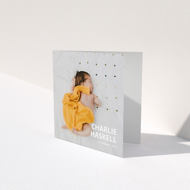 A baby card design named "Bold Photo Corner". It is a square (148mm x 148mm) card in a square orientation. It is a photographic baby card with room for 1 photo. "Bold Photo Corner" is available as a folded card, with mainly white colouring.