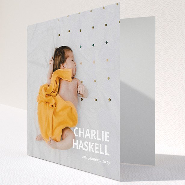 A baby card design named "Bold Photo Corner". It is a square (148mm x 148mm) card in a square orientation. It is a photographic baby card with room for 1 photo. "Bold Photo Corner" is available as a folded card, with mainly white colouring.