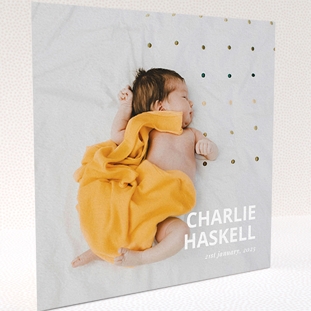A baby card design named "Bold Photo Corner". It is a square (148mm x 148mm) card in a square orientation. It is a photographic baby card with room for 1 photo. "Bold Photo Corner" is available as a folded card, with mainly white colouring.