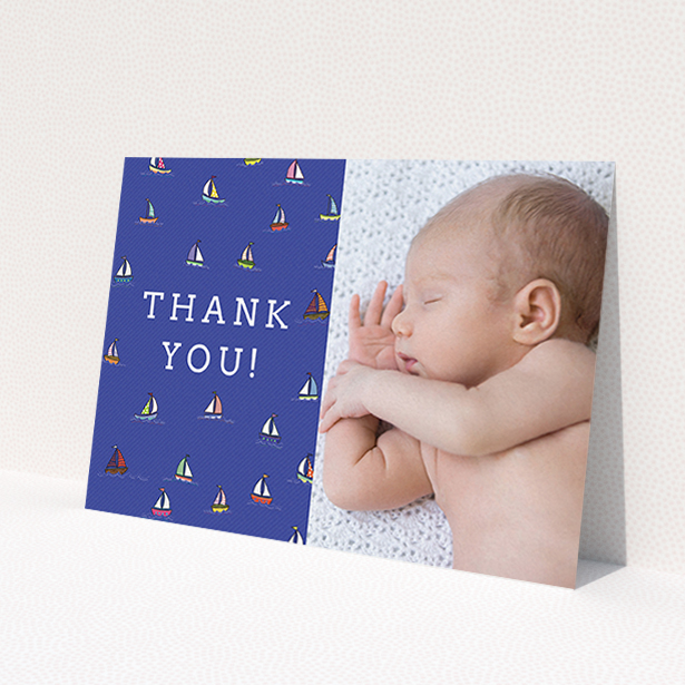 A baby card design named 'Cowes Week'. It is an A6 card in a landscape orientation. It is a photographic baby card with room for 1 photo. 'Cowes Week' is available as a flat card, with mainly blue colouring.