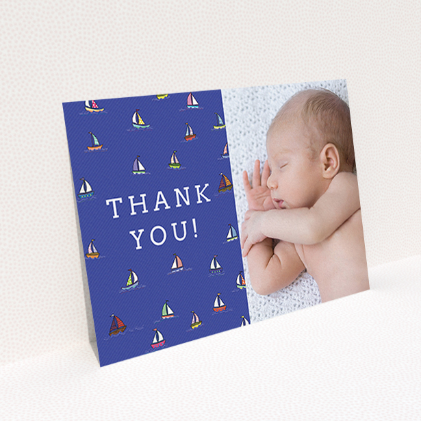 A baby card design named "Cowes Week". It is an A6 card in a landscape orientation. It is a photographic baby card with room for 1 photo. "Cowes Week" is available as a flat card, with mainly blue colouring.