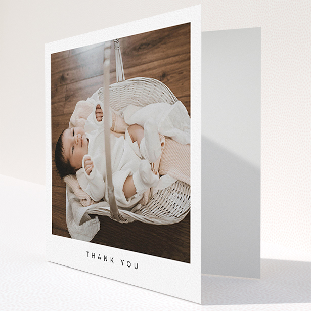 A baby card design named "Simple". It is a square (148mm x 148mm) card in a square orientation. It is a photographic baby card with room for 1 photo. "Simple" is available as a folded card, with mainly white colouring.