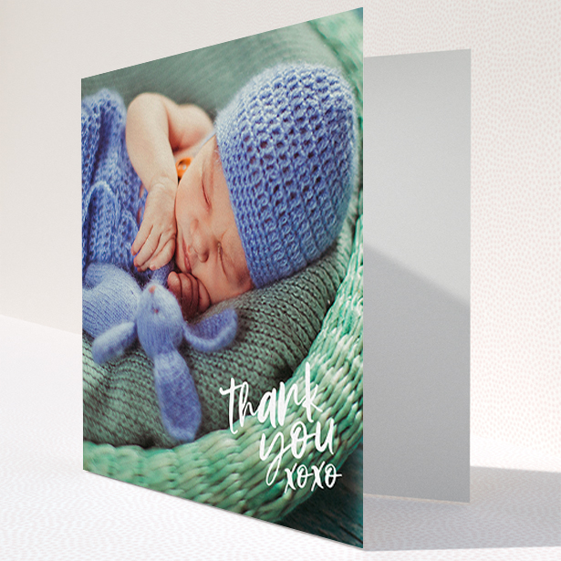 A baby card design titled "Thanks In the Corner". It is a square (148mm x 148mm) card in a square orientation. It is a photographic baby card with room for 1 photo. "Thanks In the Corner" is available as a folded card, with mainly white colouring.