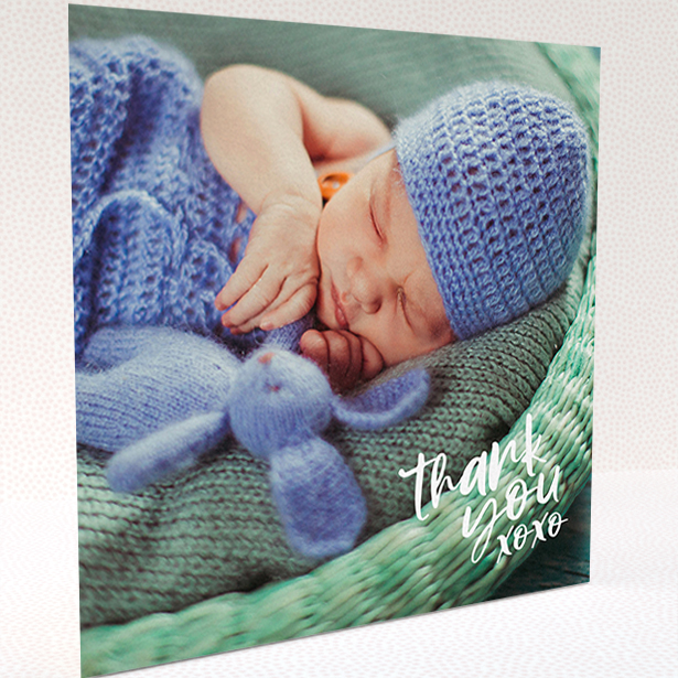 A baby card design titled "Thanks In the Corner". It is a square (148mm x 148mm) card in a square orientation. It is a photographic baby card with room for 1 photo. "Thanks In the Corner" is available as a folded card, with mainly white colouring.