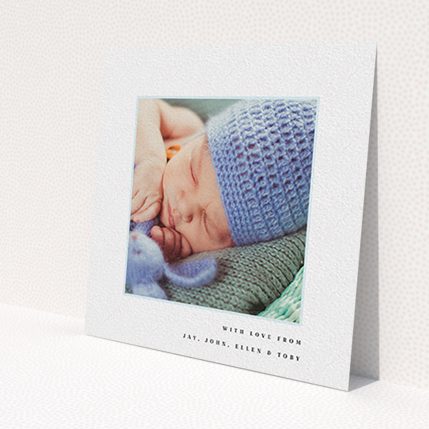 A baby card called 'Thin Blue Frame'. It is a square (148mm x 148mm) card in a square orientation. It is a photographic baby card with room for 1 photo. 'Thin Blue Frame' is available as a flat card, with tones of white and blue.