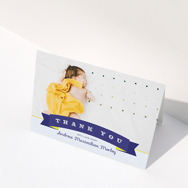 A baby thank you card design called "Big Banner". It is an A6 card in a landscape orientation. It is a photographic baby thank you card with room for 1 photo. "Big Banner" is available as a folded card, with tones of navy blue and white.