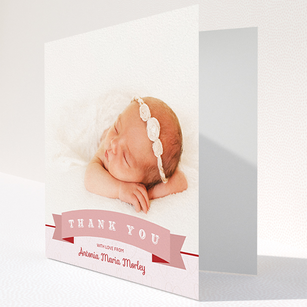 A baby thank you card named "Big Banner". It is a square (148mm x 148mm) card in a square orientation. It is a photographic baby thank you card with room for 1 photo. "Big Banner" is available as a folded card, with tones of pink and white.