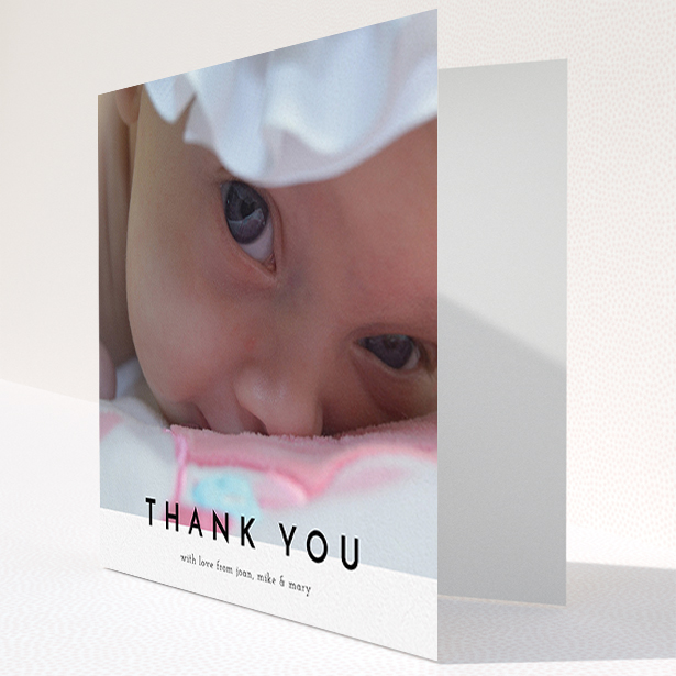 A baby thank you card design titled "Cross Border". It is a square (148mm x 148mm) card in a square orientation. It is a photographic baby thank you card with room for 1 photo. "Cross Border" is available as a folded card, with mainly white colouring.