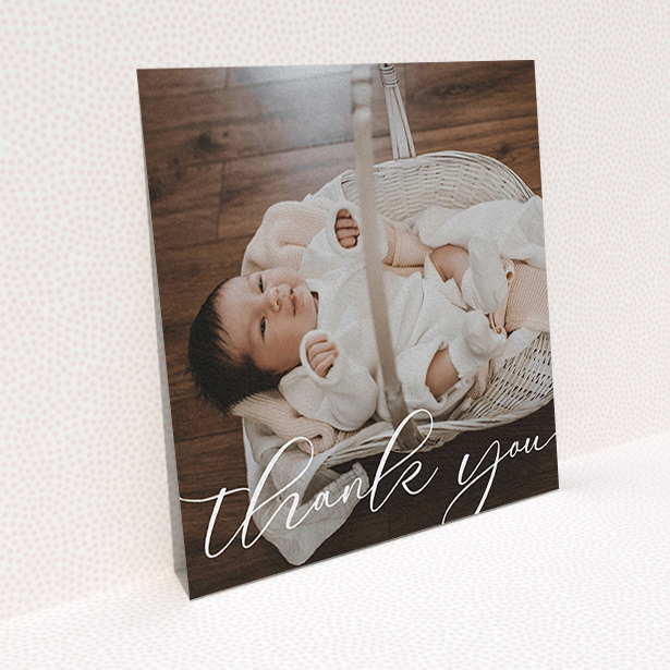 A baby thank you card template titled "One Photo". It is a square (148mm x 148mm) card in a square orientation. It is a photographic baby thank you card with room for 1 photo. "One Photo" is available as a flat card, with mainly white colouring.