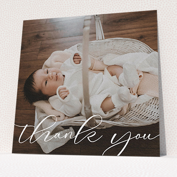 A baby thank you card template titled "One Photo". It is a square (148mm x 148mm) card in a square orientation. It is a photographic baby thank you card with room for 1 photo. "One Photo" is available as a flat card, with mainly white colouring.