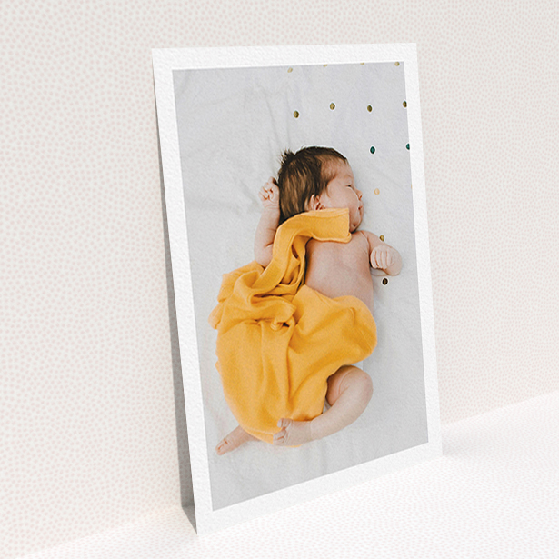 A baby thank you card design titled "One Photo Thanks". It is an A6 card in a portrait orientation. It is a photographic baby thank you card with room for 1 photo. "One Photo Thanks" is available as a flat card, with mainly white colouring.
