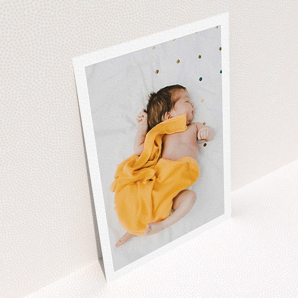 A baby thank you card design titled "One Photo Thanks". It is an A6 card in a portrait orientation. It is a photographic baby thank you card with room for 1 photo. "One Photo Thanks" is available as a flat card, with mainly white colouring.