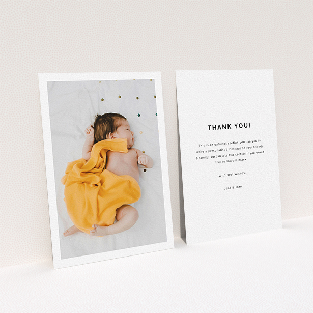 A baby thank you card design titled "One Photo Thanks". It is an A6 card in a portrait orientation. It is a photographic baby thank you card with room for 1 photo. "One Photo Thanks" is available as a flat card, with mainly white colouring.