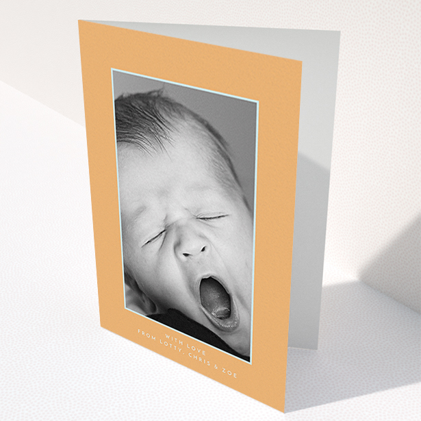 A baby thank you card design named "Orange and Mint". It is an A6 card in a portrait orientation. It is a photographic baby thank you card with room for 1 photo. "Orange and Mint" is available as a folded card, with tones of orange and blue.
