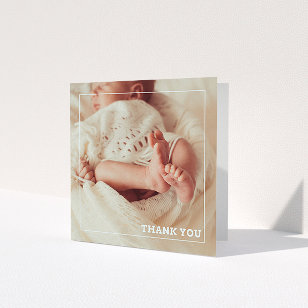 A baby thank you card design called 'Over Photo Frame'. It is a square (148mm x 148mm) card in a square orientation. It is a photographic baby thank you card with room for 1 photo. 'Over Photo Frame' is available as a folded card, with mainly white colouring.