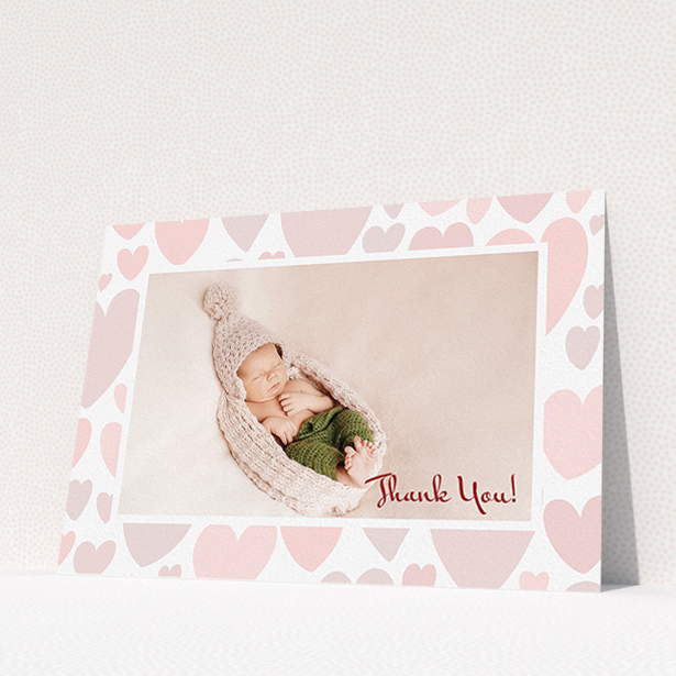 A baby thank you card design called "Pastel Hearts". It is an A5 card in a landscape orientation. It is a photographic baby thank you card with room for 1 photo. "Pastel Hearts" is available as a flat card, with tones of pink and white.