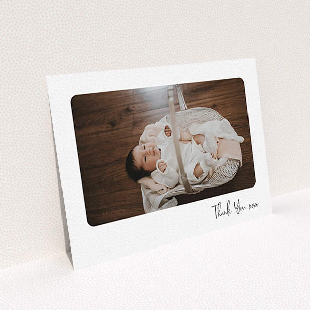 A baby thank you card design named "Rounded Thanks". It is an A6 card in a landscape orientation. It is a photographic baby thank you card with room for 1 photo. "Rounded Thanks" is available as a flat card, with mainly white colouring.