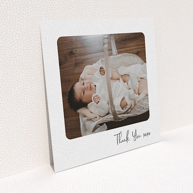 A baby thank you card named "Rounded Thanks". It is a square (148mm x 148mm) card in a square orientation. It is a photographic baby thank you card with room for 1 photo. "Rounded Thanks" is available as a flat card, with mainly white colouring.