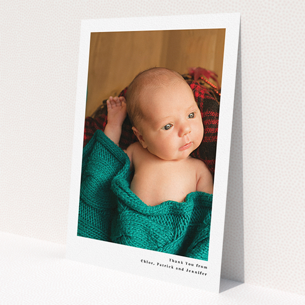 A baby thank you card design called 'Simple Portrait'. It is an A5 card in a portrait orientation. It is a photographic baby thank you card with room for 1 photo. 'Simple Portrait' is available as a flat card, with mainly white colouring.