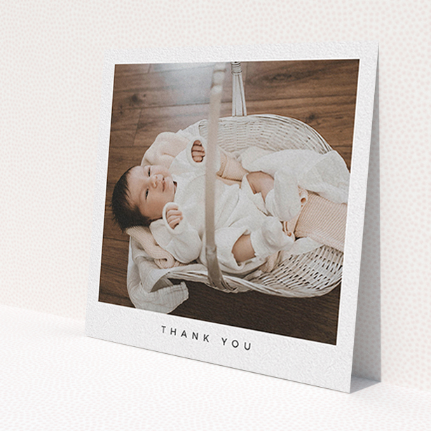 A baby thank you card called 'Simple'. It is a square (148mm x 148mm) card in a square orientation. It is a photographic baby thank you card with room for 1 photo. 'Simple' is available as a flat card, with mainly white colouring.