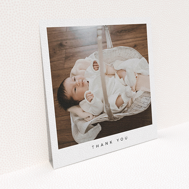A baby thank you card called "Simple". It is a square (148mm x 148mm) card in a square orientation. It is a photographic baby thank you card with room for 1 photo. "Simple" is available as a flat card, with mainly white colouring.