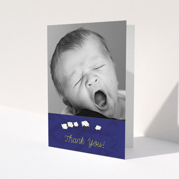 A baby thank you card named 'Sleepy Time'. It is an A5 card in a portrait orientation. It is a photographic baby thank you card with room for 1 photo. 'Sleepy Time' is available as a folded card, with tones of navy blue and white.