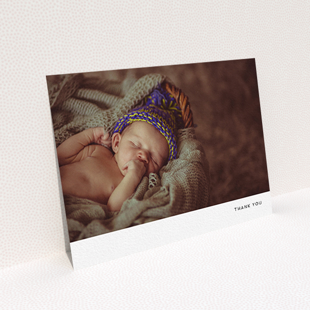 A baby thank you card named "Thankful with Simplicity". It is an A6 card in a landscape orientation. It is a photographic baby thank you card with room for 1 photo. "Thankful with Simplicity" is available as a flat card, with mainly white colouring.