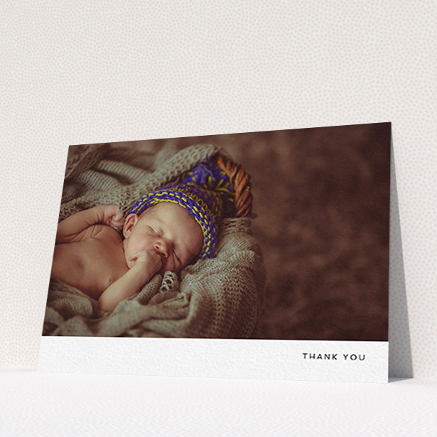 A baby thank you card named "Thankful with Simplicity". It is an A6 card in a landscape orientation. It is a photographic baby thank you card with room for 1 photo. "Thankful with Simplicity" is available as a flat card, with mainly white colouring.