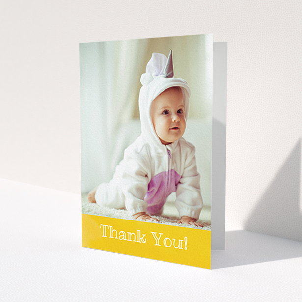 A baby thank you card called 'Thanks In Yellow'. It is an A6 card in a portrait orientation. It is a photographic baby thank you card with room for 1 photo. 'Thanks In Yellow' is available as a folded card, with tones of yellow and white.