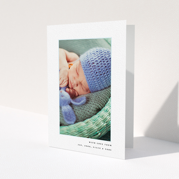 A baby thank you card template titled 'Thin Blue Frame'. It is an A6 card in a portrait orientation. It is a photographic baby thank you card with room for 1 photo. 'Thin Blue Frame' is available as a folded card, with tones of white and blue.