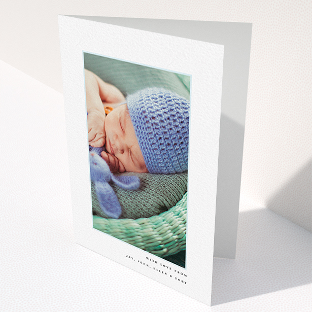 A baby thank you card template titled "Thin Blue Frame". It is an A6 card in a portrait orientation. It is a photographic baby thank you card with room for 1 photo. "Thin Blue Frame" is available as a folded card, with tones of white and blue.