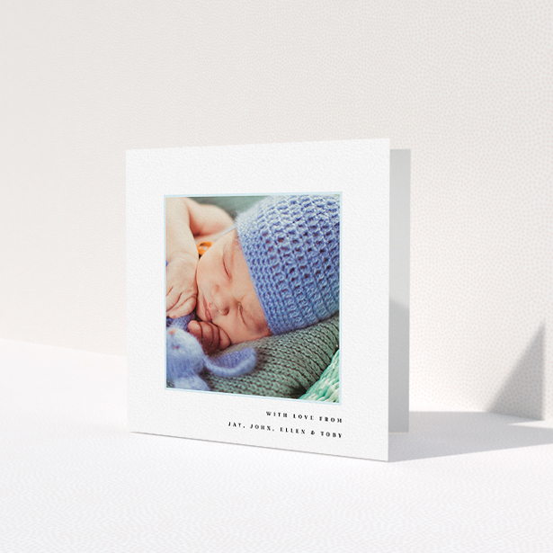 A baby thank you card design named 'Thin Blue Frame'. It is a square (148mm x 148mm) card in a square orientation. It is a photographic baby thank you card with room for 1 photo. 'Thin Blue Frame' is available as a folded card, with tones of white and blue.