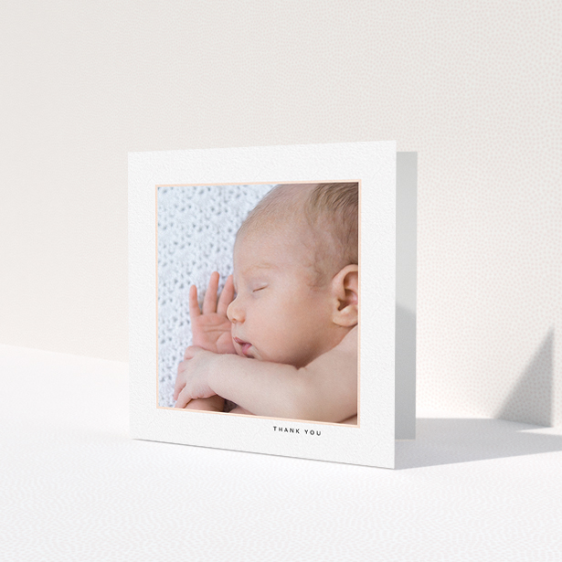 A baby thank you card template titled 'Thin Pink Frame'. It is a square (148mm x 148mm) card in a square orientation. It is a photographic baby thank you card with room for 1 photo. 'Thin Pink Frame' is available as a folded card, with tones of white and pink.