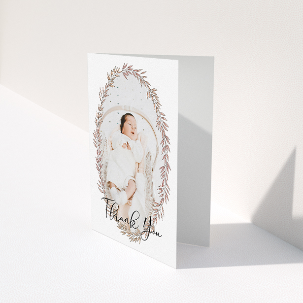 A baby thank you card called "Tussled Wreath". It is an A5 card in a portrait orientation. It is a photographic baby thank you card with room for 1 photo. "Tussled Wreath" is available as a folded card, with mainly pink colouring.