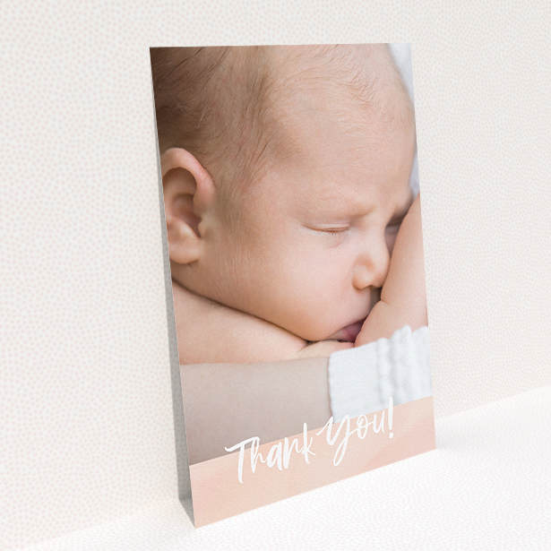 A baby thank you card design titled "Watercolour Thanks". It is an A5 card in a portrait orientation. It is a photographic baby thank you card with room for 1 photo. "Watercolour Thanks" is available as a flat card, with tones of pink and white.