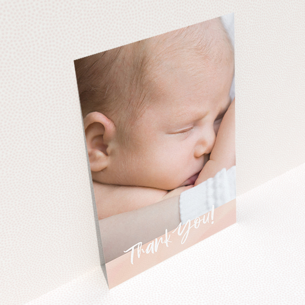 A baby thank you card design titled "Watercolour Thanks". It is an A5 card in a portrait orientation. It is a photographic baby thank you card with room for 1 photo. "Watercolour Thanks" is available as a flat card, with tones of pink and white.