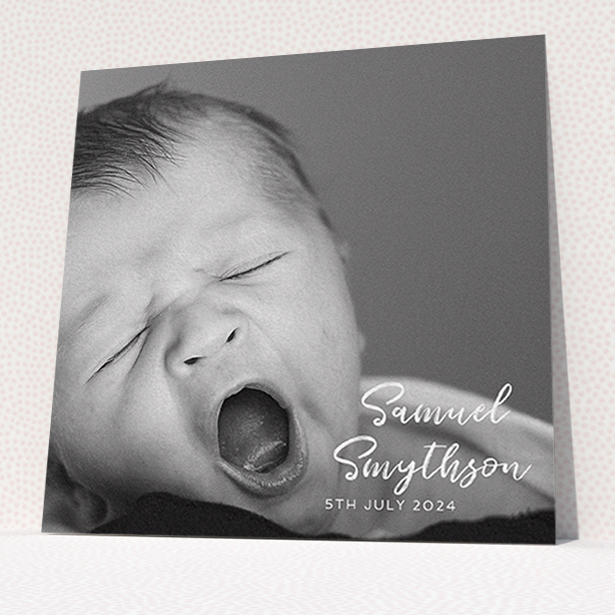 A baptism invitation called "Soho Script". It is a square (148mm x 148mm) invite card in a square orientation. It is a photographic baptism invitation with room for 1 photo. "Soho Script" is available as a flat invite card, with mainly white colouring.