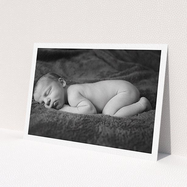 A baptism invitation called 'Thick White Framed Photo'. It is an A6 invite card in a landscape orientation. It is a photographic baptism invitation with room for 1 photo. 'Thick White Framed Photo' is available as a flat invite card, with mainly white colouring.