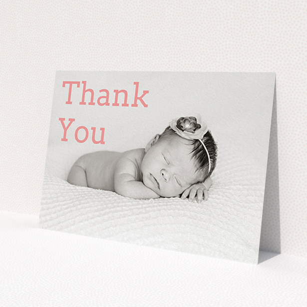 A baptism thank you card design called 'Big Thanks'. It is an A6 card in a landscape orientation. It is a photographic baptism thank you card with room for 1 photo. 'Big Thanks' is available as a flat card, with mainly light pink colouring.