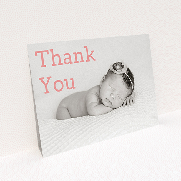 A baptism thank you card design called "Big Thanks". It is an A6 card in a landscape orientation. It is a photographic baptism thank you card with room for 1 photo. "Big Thanks" is available as a flat card, with mainly light pink colouring.