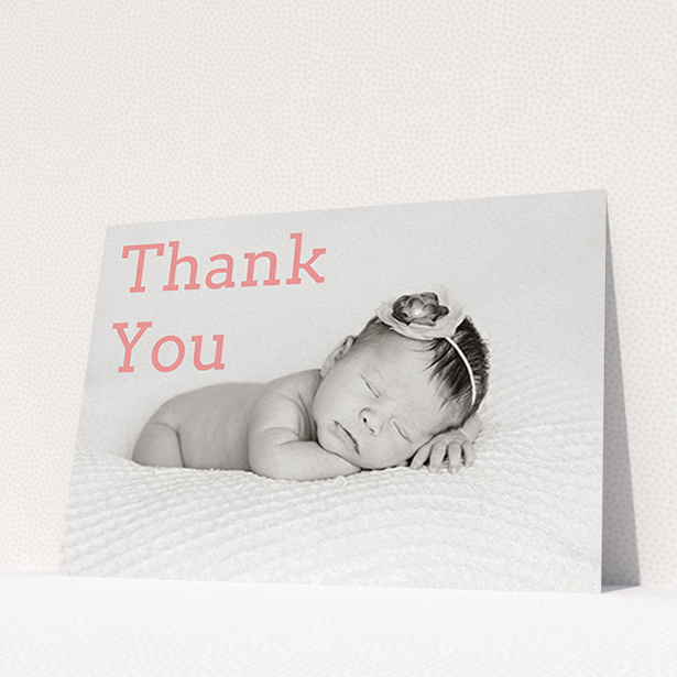 A baptism thank you card design called "Big Thanks". It is an A6 card in a landscape orientation. It is a photographic baptism thank you card with room for 1 photo. "Big Thanks" is available as a flat card, with mainly light pink colouring.