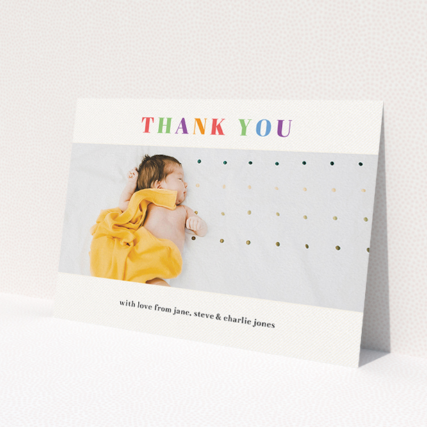 A baptism thank you card design named 'Colourful Thanks'. It is an A5 card in a landscape orientation. It is a photographic baptism thank you card with room for 1 photo. 'Colourful Thanks' is available as a flat card, with tones of white and orange.