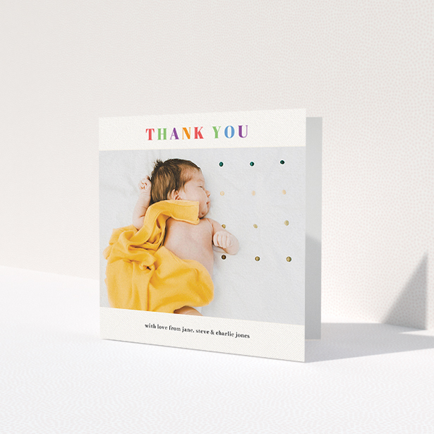 A baptism thank you card design titled 'Colourful Thanks'. It is a square (148mm x 148mm) card in a square orientation. It is a photographic baptism thank you card with room for 1 photo. 'Colourful Thanks' is available as a folded card, with tones of white and orange.
