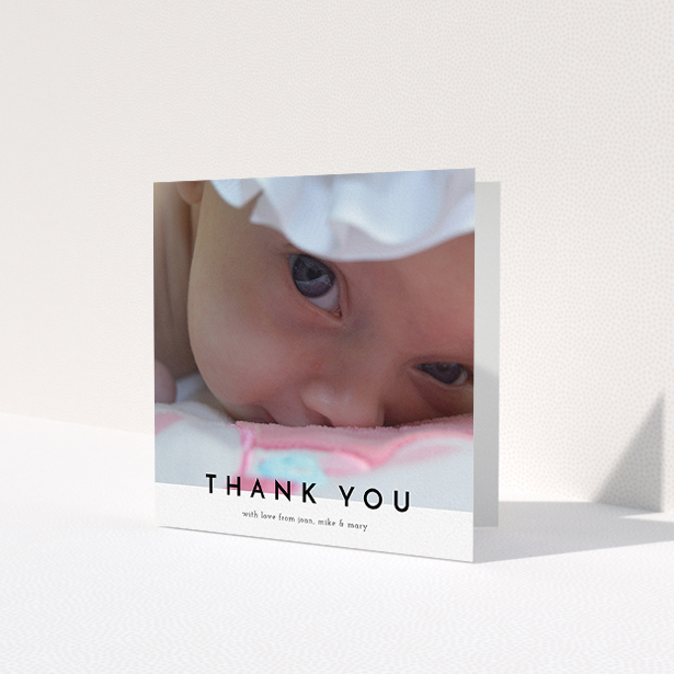 A baptism thank you card design named 'Cross Border'. It is a square (148mm x 148mm) card in a square orientation. It is a photographic baptism thank you card with room for 1 photo. 'Cross Border' is available as a folded card, with mainly white colouring.
