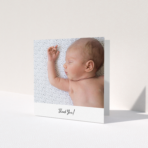 A baptism thank you card template titled 'Mr & Mrs Footer'. It is a square (148mm x 148mm) card in a square orientation. It is a photographic baptism thank you card with room for 1 photo. 'Mr & Mrs Footer' is available as a folded card, with mainly white colouring.