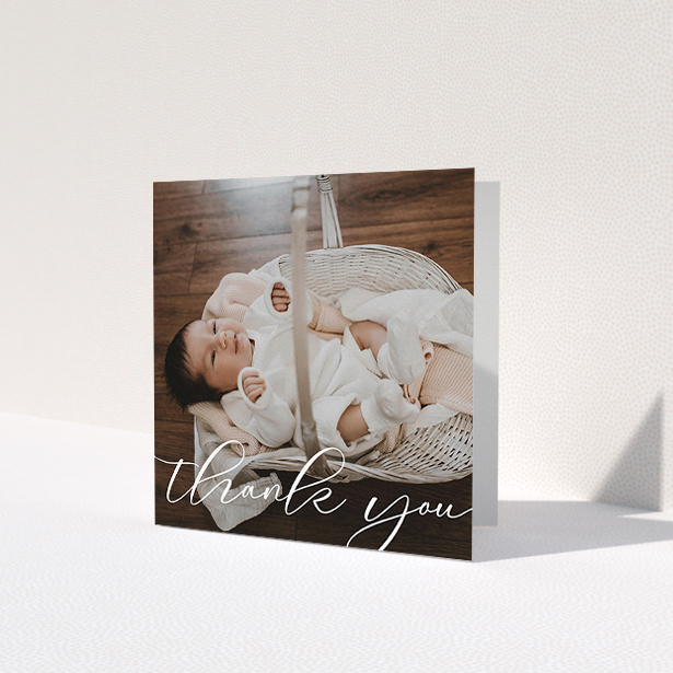 A baptism thank you card named 'One Photo'. It is a square (148mm x 148mm) card in a square orientation. It is a photographic baptism thank you card with room for 1 photo. 'One Photo' is available as a folded card, with mainly white colouring.