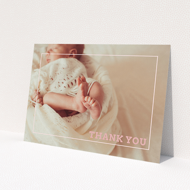 A baptism thank you card called 'Over Photo Frame'. It is an A5 card in a landscape orientation. It is a photographic baptism thank you card with room for 1 photo. 'Over Photo Frame' is available as a flat card, with mainly light pink colouring.