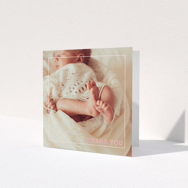 A baptism thank you card called 'Over Photo Frame'. It is a square (148mm x 148mm) card in a square orientation. It is a photographic baptism thank you card with room for 1 photo. 'Over Photo Frame' is available as a folded card, with mainly light pink colouring.