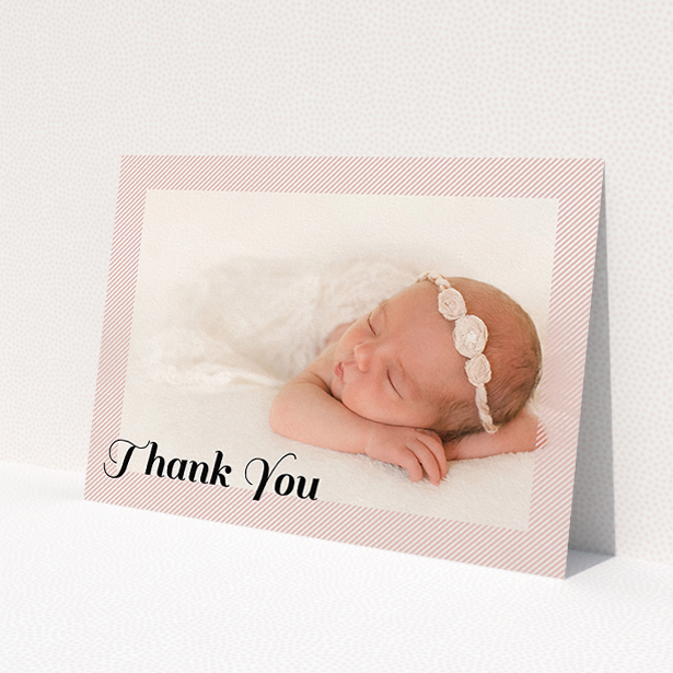 A baptism thank you card design named 'Pastel Diagonals'. It is an A5 card in a landscape orientation. It is a photographic baptism thank you card with room for 1 photo. 'Pastel Diagonals' is available as a flat card, with mainly pink colouring.