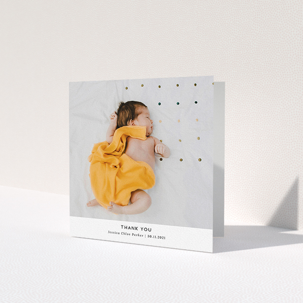 A baptism thank you card design titled 'Sans Serif'. It is a square (148mm x 148mm) card in a square orientation. It is a photographic baptism thank you card with room for 1 photo. 'Sans Serif' is available as a folded card, with mainly white colouring.